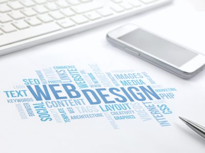 Web Design business concept word cloud print document, keyboard, pen and smartphone, keyboard, pen and smartphone. Blue toned.